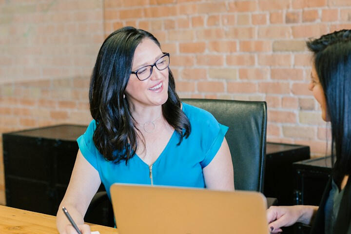 Illustrative stock photo of a business conversation; not our team or candidates.